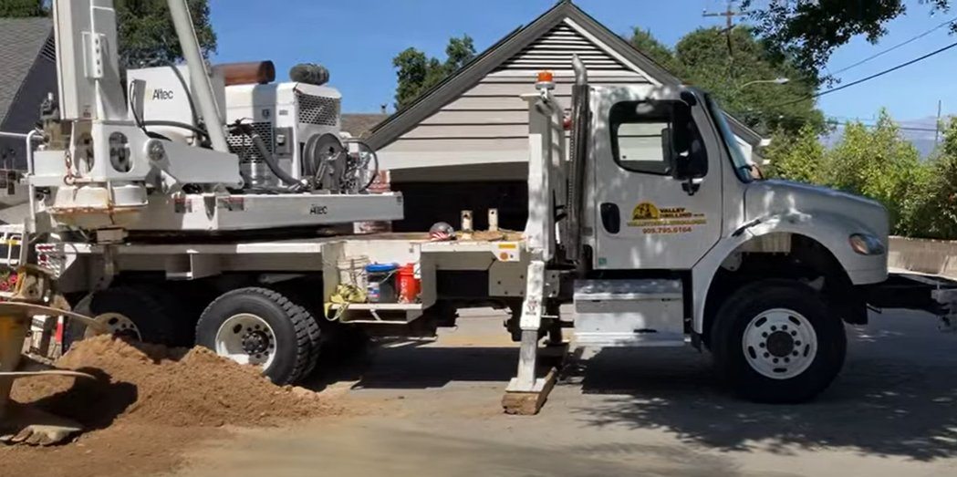 Valley Drilling Altec drill rig truck on a neighborhood job